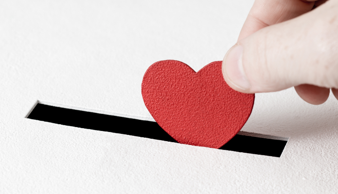 paper heart being put into a box