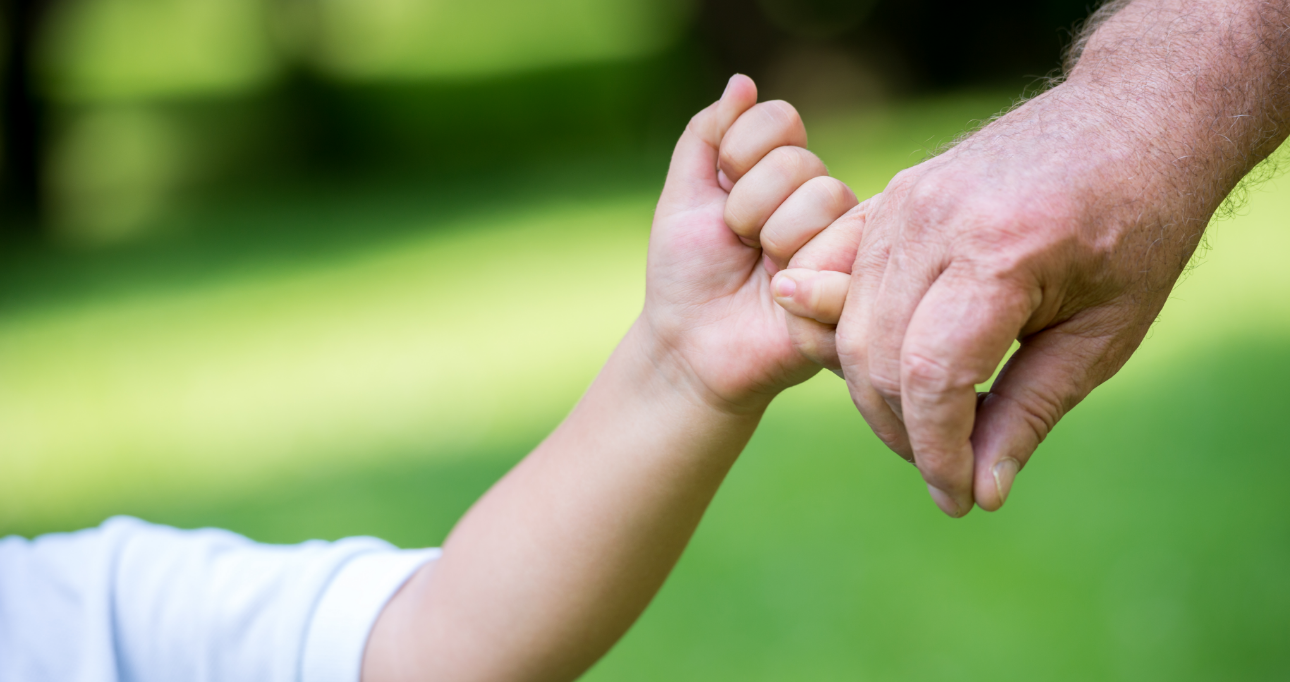 father and son holding hands