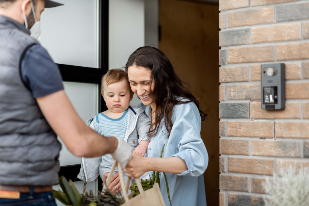 man delivering produce to a womans front door