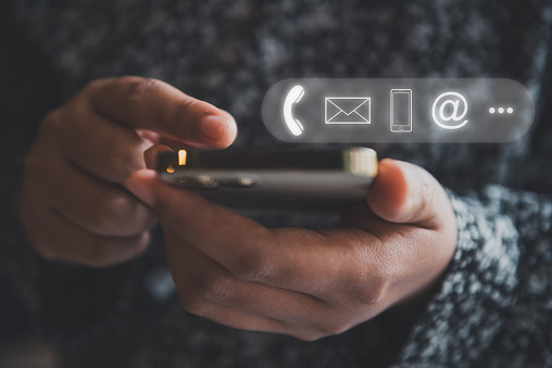 man checking cell phone with visual communication symbols