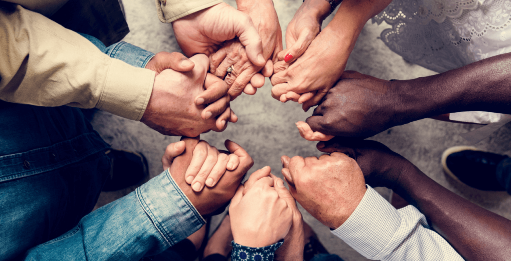 group of diverse people holding hands