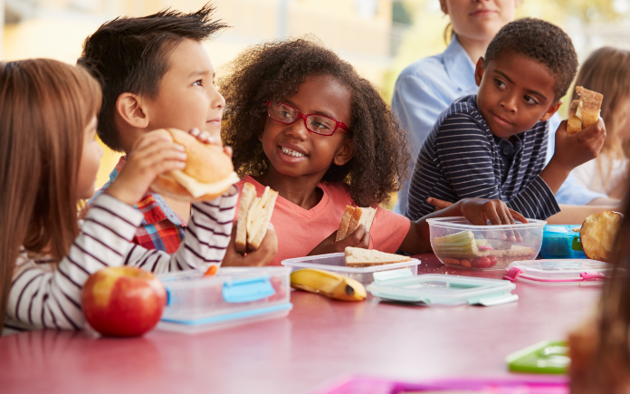small children eating lunch at school