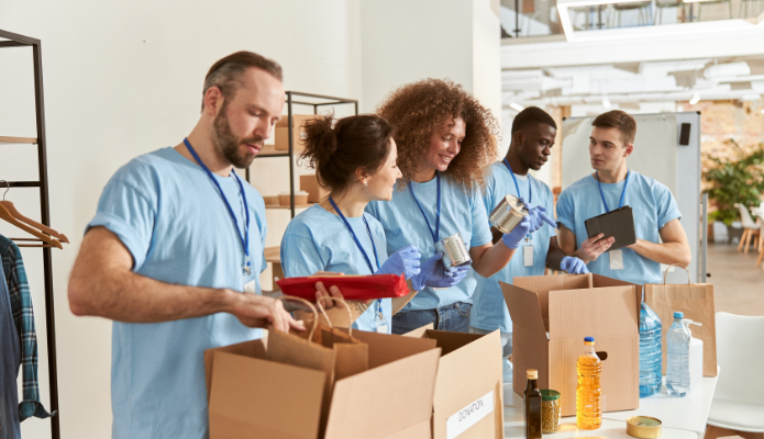 group of volunteers sorting food into boxes