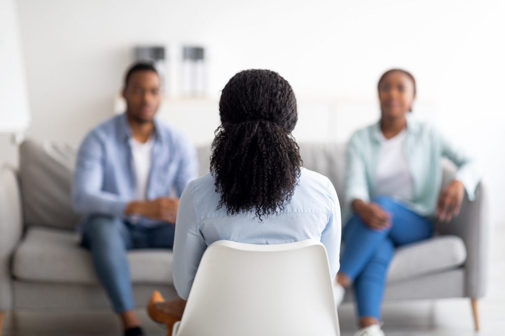 woman talks to couple